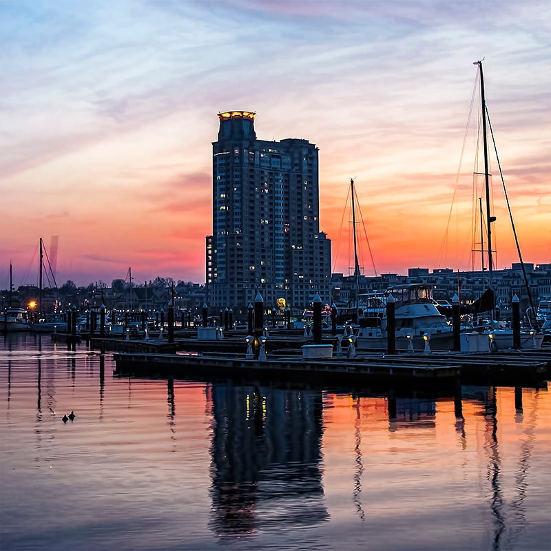 A colorful sky develops as the sun sets over the Baltimore harbor.