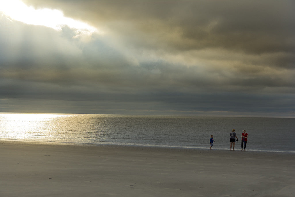 A transitioning morning sky, a whirling wind and an amazing down-burst of sunlight combine for a rare image along the shores of Hilton Head Island.