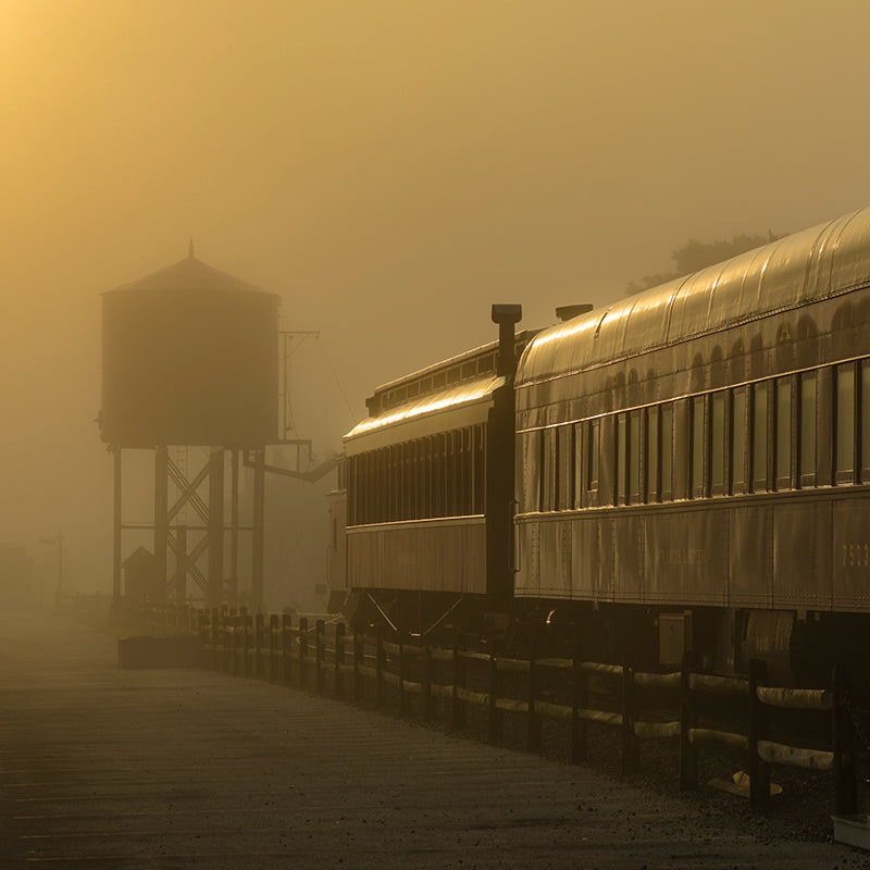 A rising sun burns through heavy fog in Strasburg Pennsylvania.