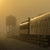 A rising sun burns through heavy fog in Strasburg Pennsylvania.
