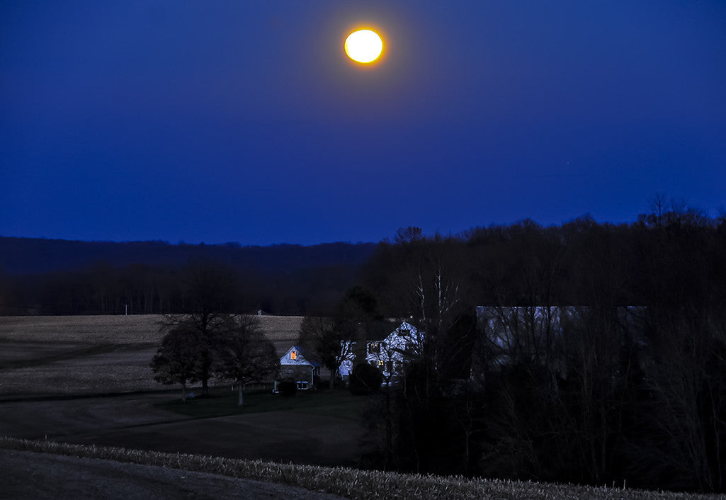 A rising moon shines brightly over a farm in Baltimore County.
